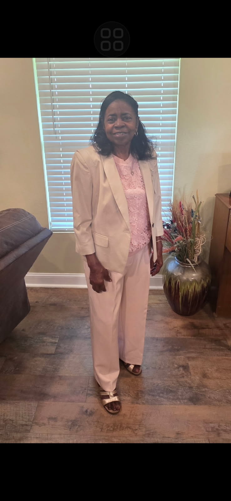 Lucille T. Bonvillian standing in a blush suit